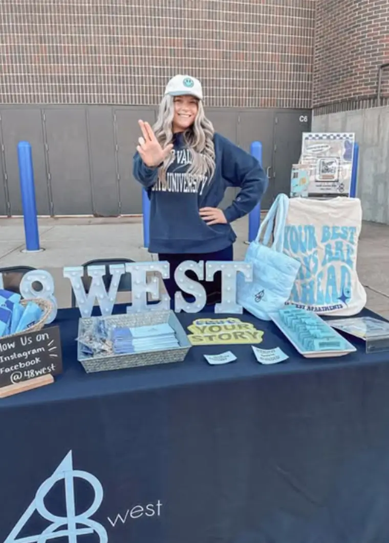 woman working a 48 West promotional booth