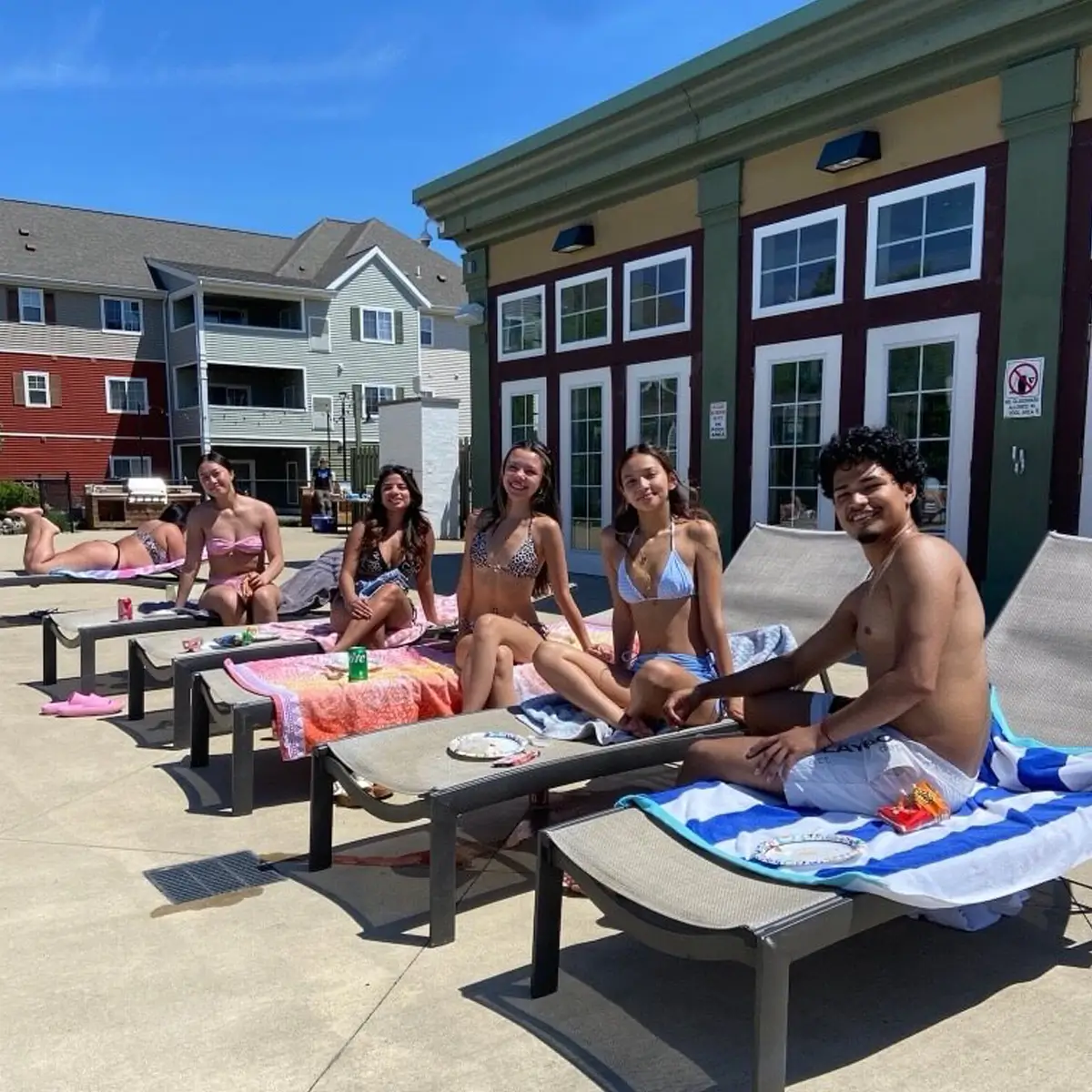 young adults relaxing the by the pool